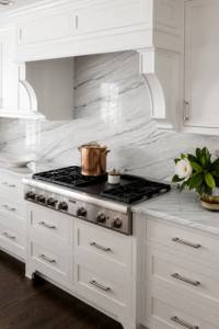Statuario quartzite countertops and full-height backsplash with grey veining in a white traditional kitchen