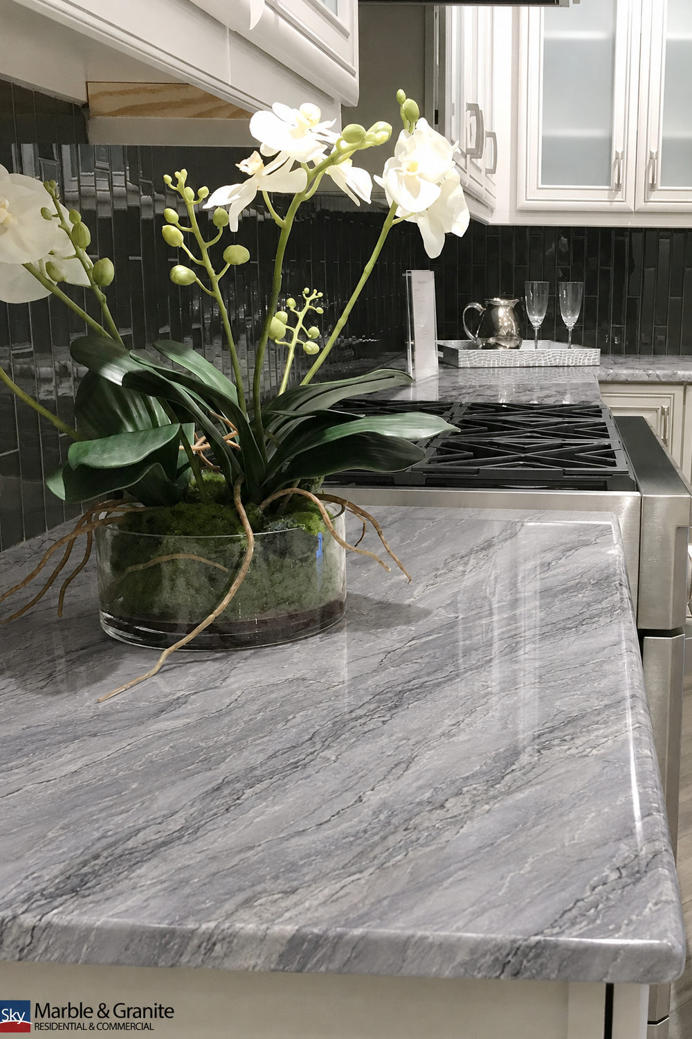 Smoky Textured quartzite countertop with soft grey veining beside a range and dark tile backsplash