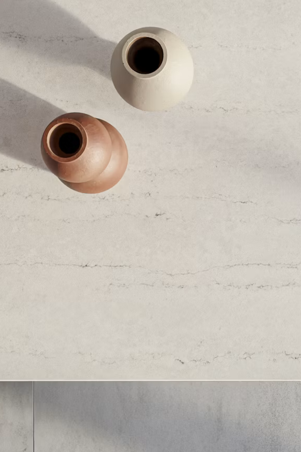 Raw A Silestone quartz surface with a pale concrete-look finish and faint horizontal striations