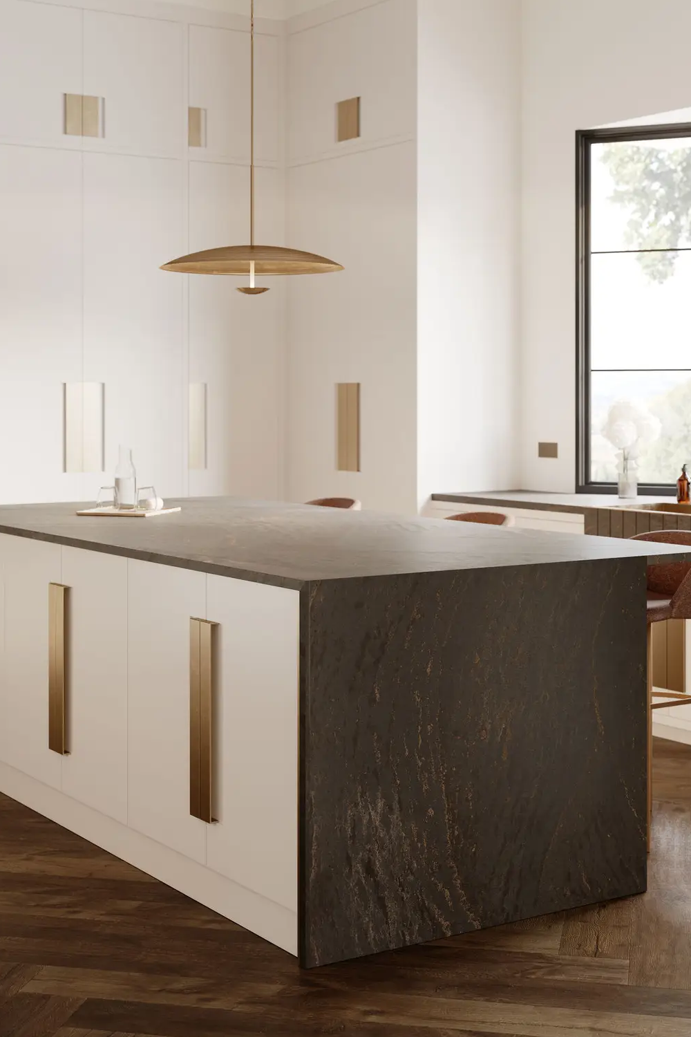 Remington Brass Cambria dark quartz waterfall island with mineral texture, cream cabinets and brass pulls