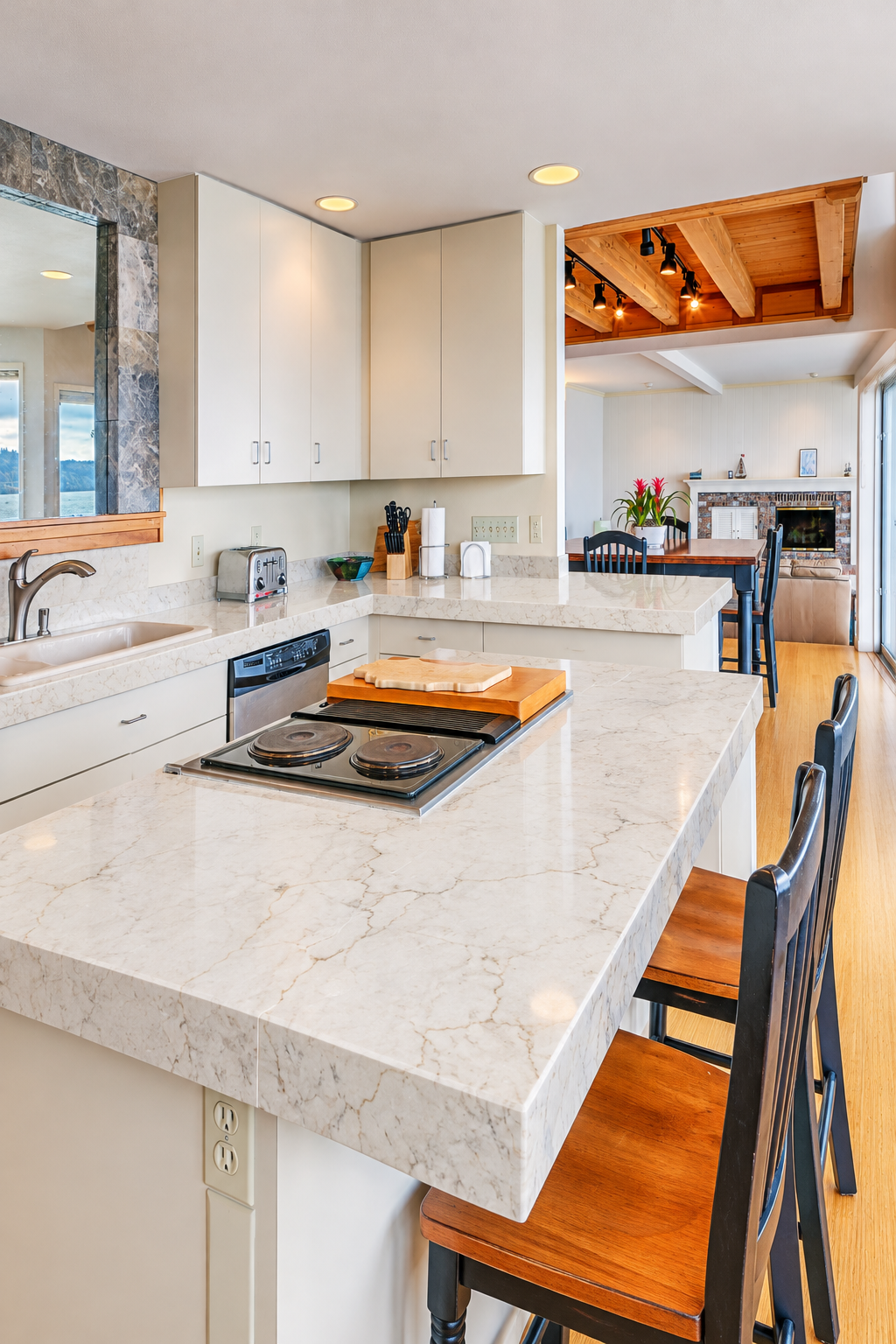 Coastal Kitchen with Calacatta Miraggio Cove Stone Counters and high chairs
