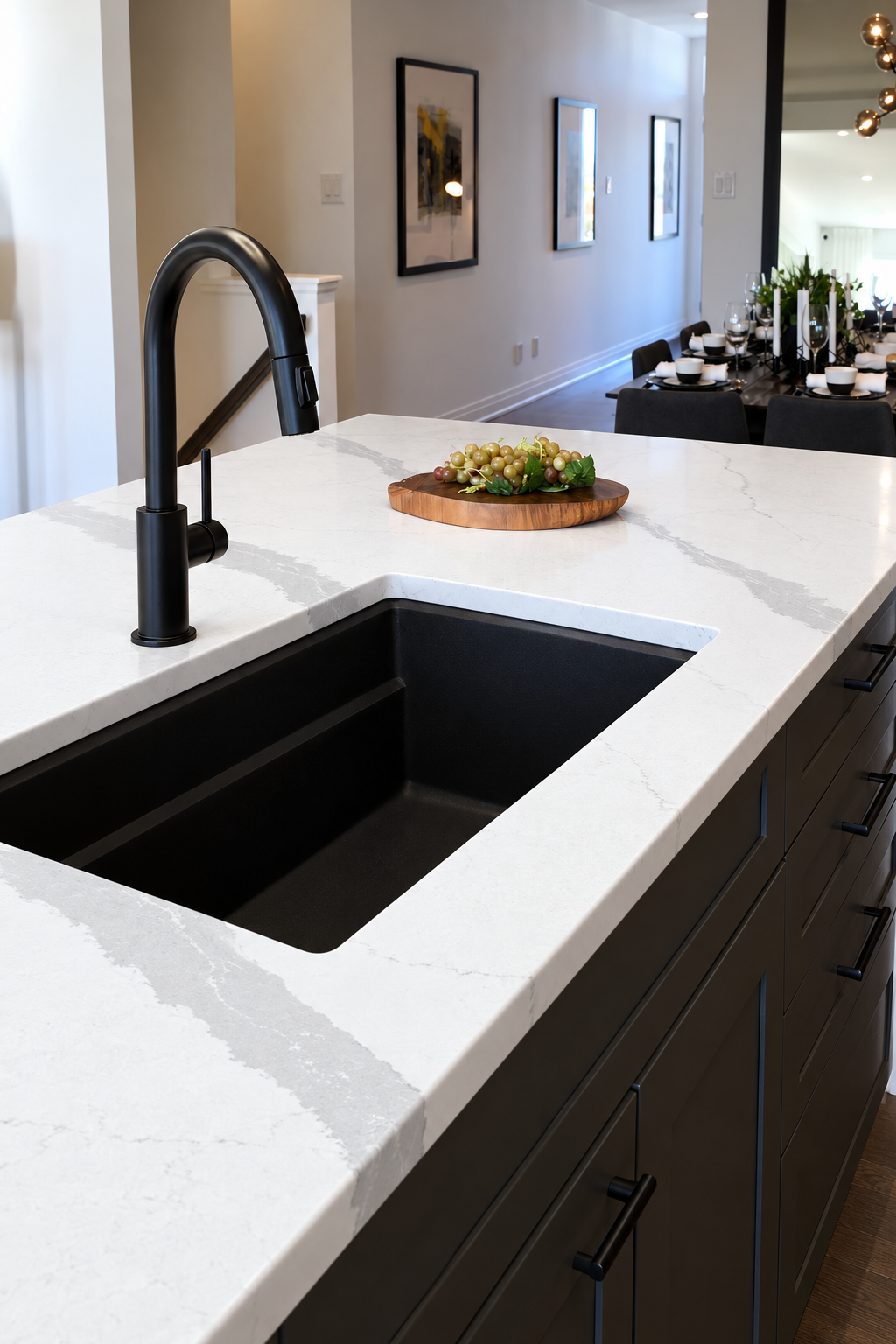 Contemporary Bianco Calacatta Island Kitchen with black sink and counter.